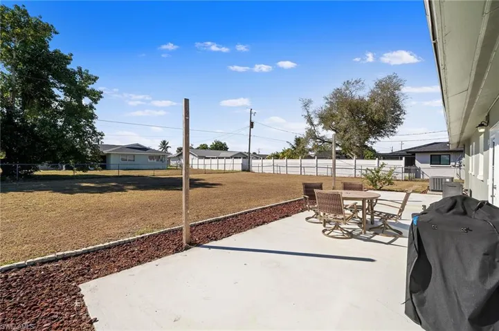 Fenced backyard featuring outdoor dining area, a patio, and area for grilling