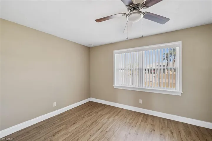 Unfurnished room featuring wood finished floors and ceiling fan