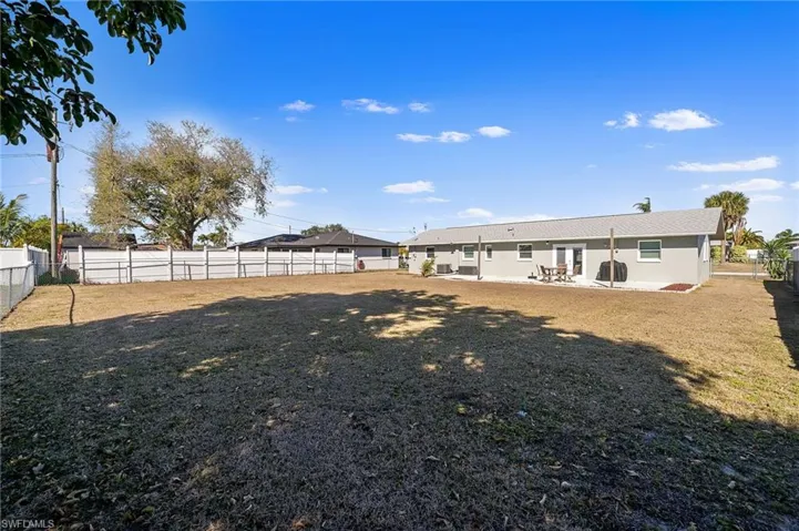 Back of property featuring a fenced backyard and a patio area