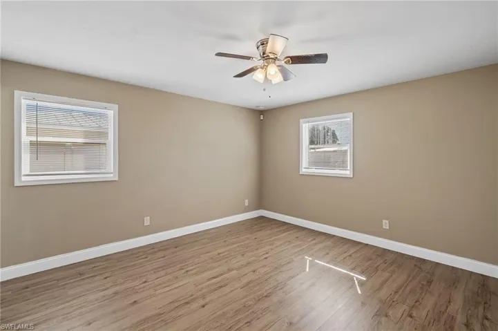 Unfurnished room featuring wood finished floors and ceiling fan