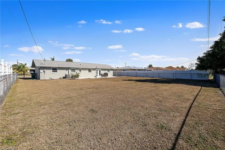 Back of property featuring a fenced backyard and a patio area