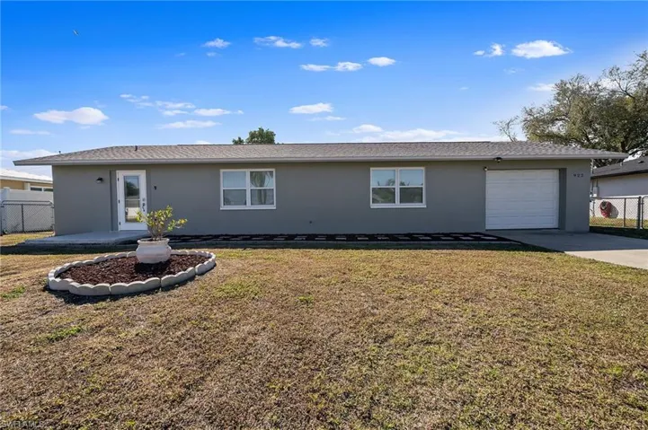 View of front of house featuring stucco siding, concrete driveway, an attached garage, and a patio