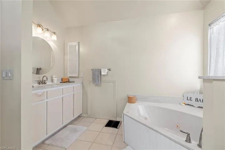 Bathroom featuring vanity, toilet, and tile patterned floors