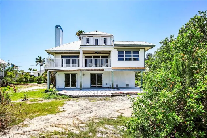 Back of property with a balcony
