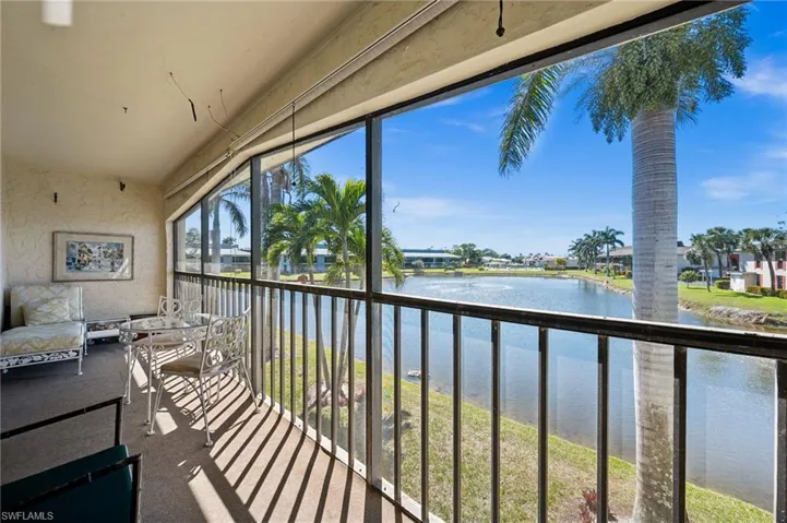 Sunroom featuring a water view