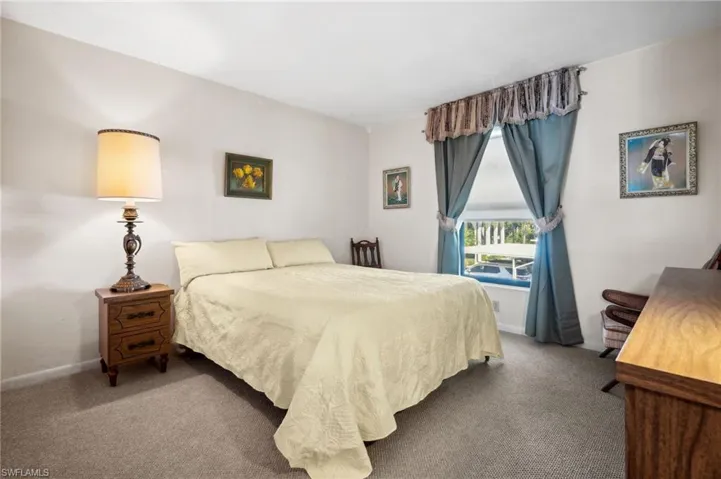 Carpeted bedroom featuring baseboards