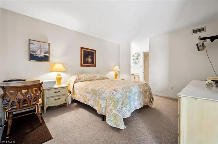 Carpeted bedroom featuring visible vents