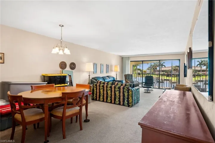 Dining area with a notable chandelier and carpet floors