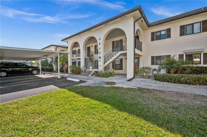 View of property featuring covered parking
