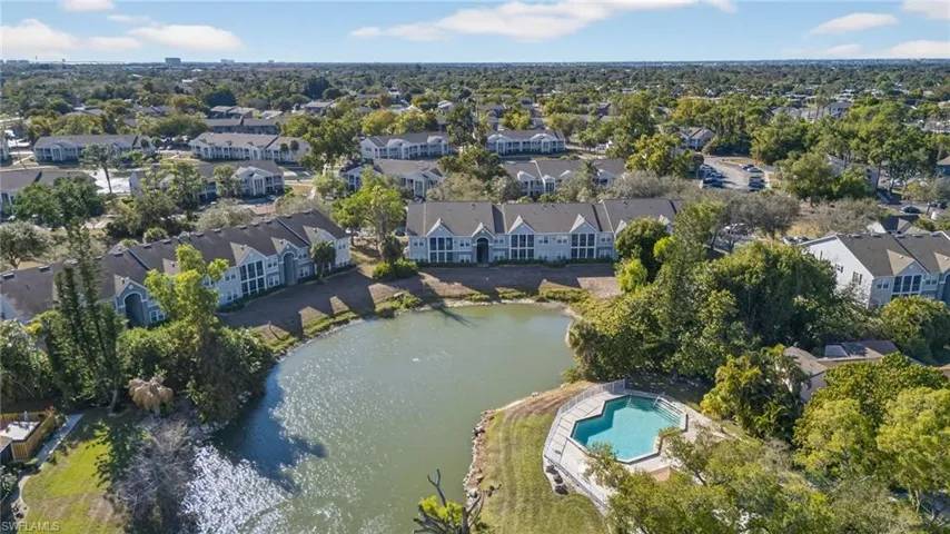 Aerial view of property's location with a nearby body of water and nearby suburban area