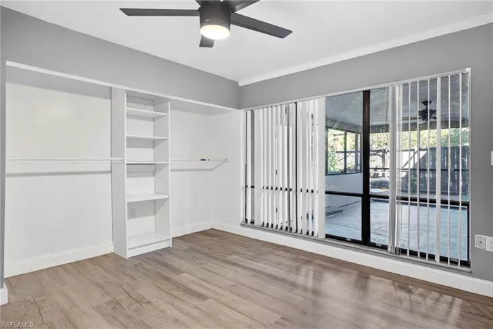 Unfurnished bedroom featuring light wood-type flooring, ceiling fan, a closet, and ornamental molding