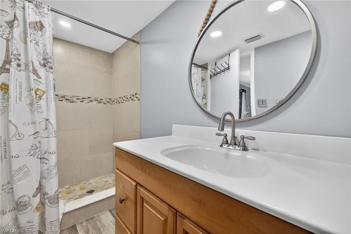 Full bathroom 2 with a stall shower, vanity, recessed lighting, and light wood finished floors