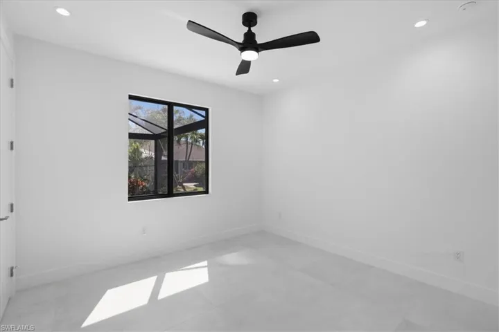 Empty room featuring a ceiling fan and recessed lighting