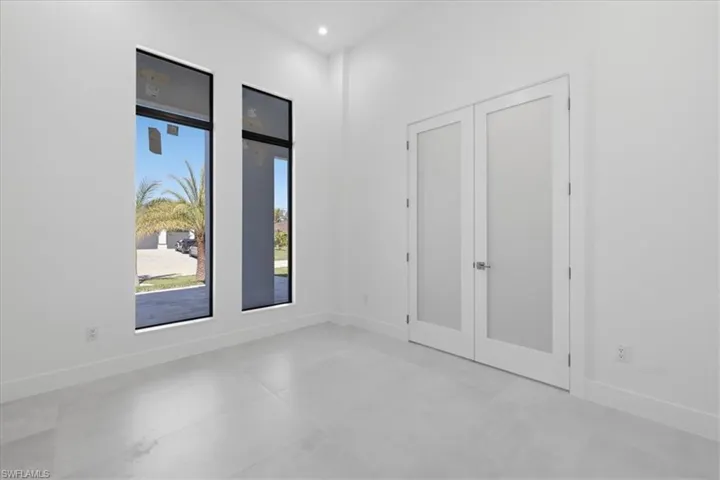 Unfurnished bedroom featuring french doors and recessed lighting