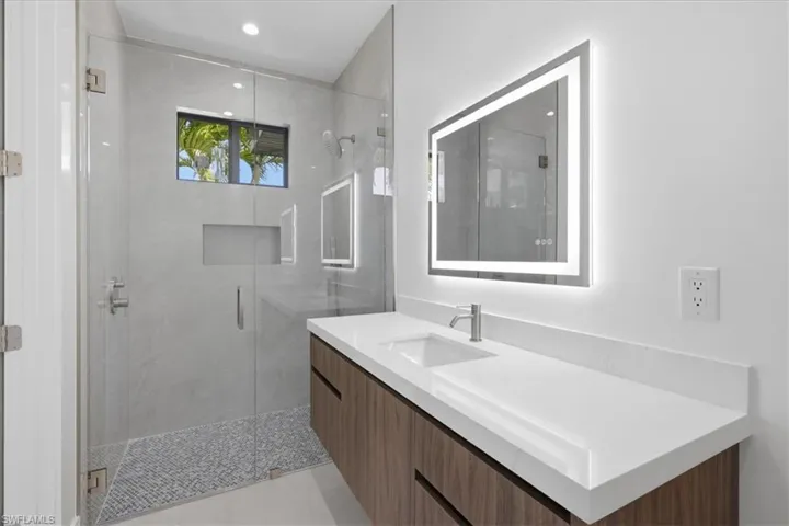 Bathroom featuring vanity and a stall shower