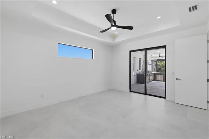 Spare room featuring ceiling fan, recessed lighting, and a tray ceiling