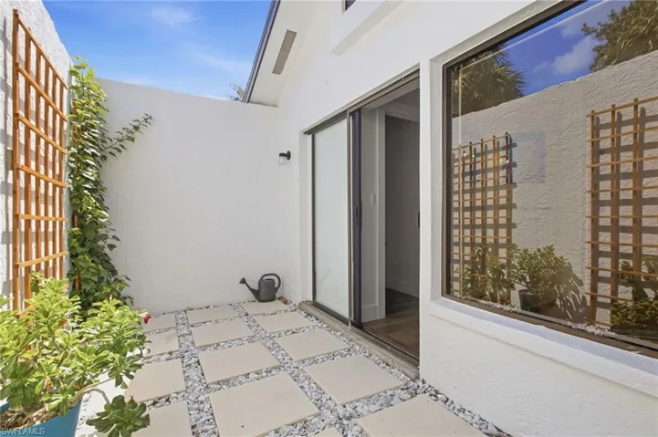 Tucked just off the primary bath is a private outdoor patio, bathed in natural light and perfectly positioned for a quiet moment of fresh air.