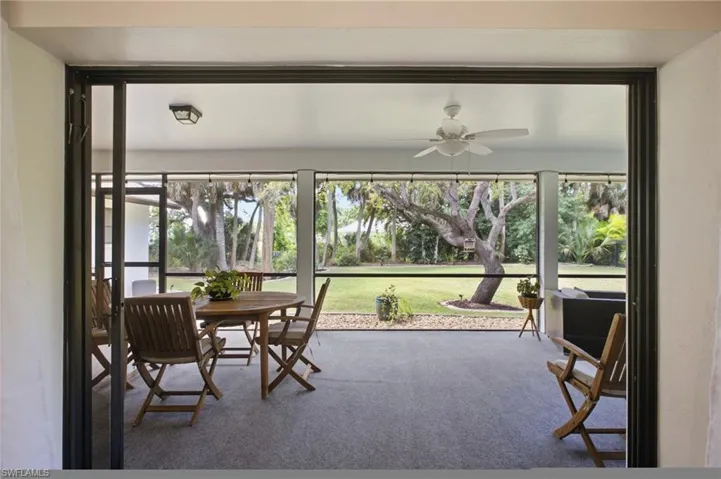 From the moment you enter, your eye is drawn straight through to that expansive view of lush backyard landscaping, setting a calm, welcoming tone.