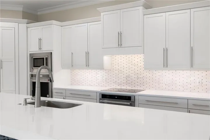 Soft close cabinets, quartz countertops, custom tile backsplash & brand new GE stainless steel appliances