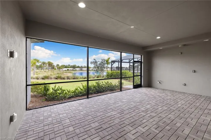 Gracious covered lanai is pre-wired for outdoor kitchen, fans and tv
