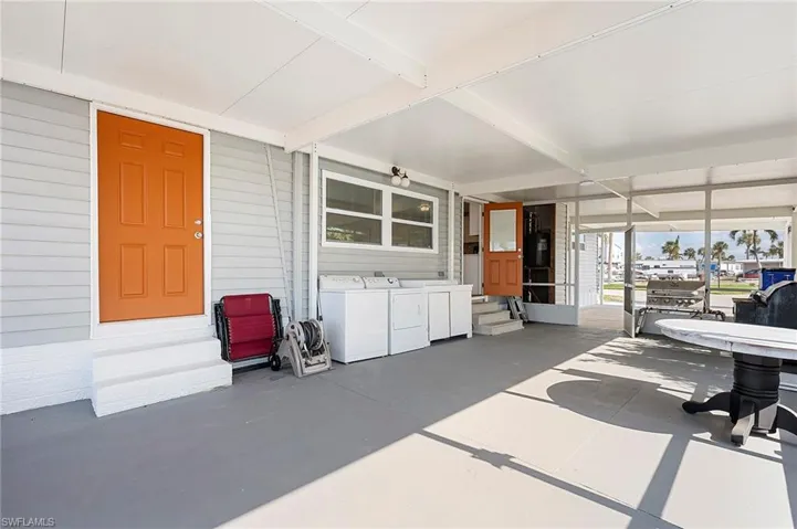 Sunroom with washer and dryer and beamed ceiling