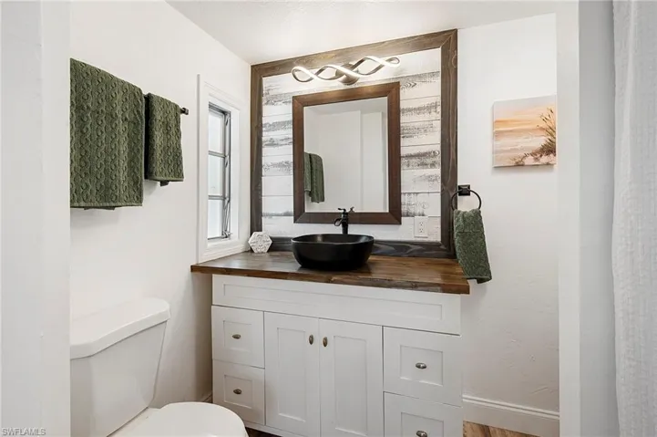 Bathroom featuring vanity and toilet