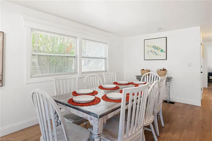 Dining space with a wealth of natural light and light wood-type flooring