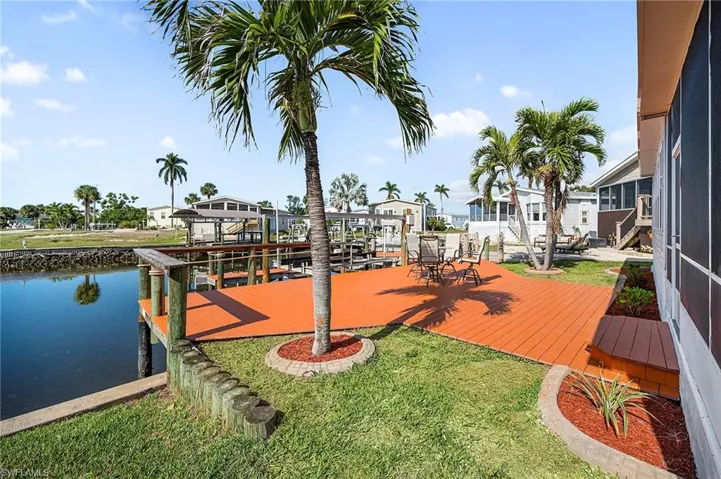 View of dock with a water view and a yard