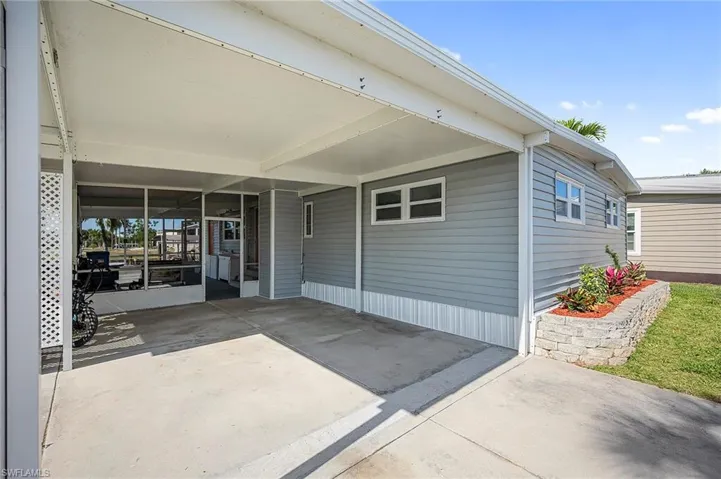 Entrance to property featuring a carport