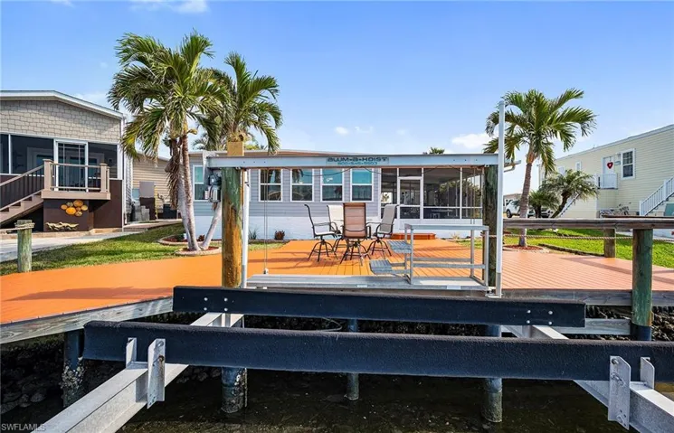 Back of house featuring a sunroom and a deck