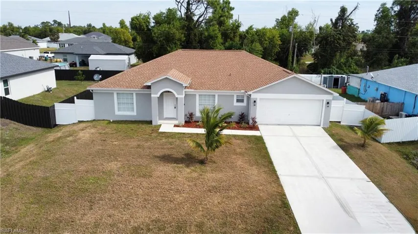 Ranch-style house featuring stucco siding, driveway, roof with shingles, and a garage