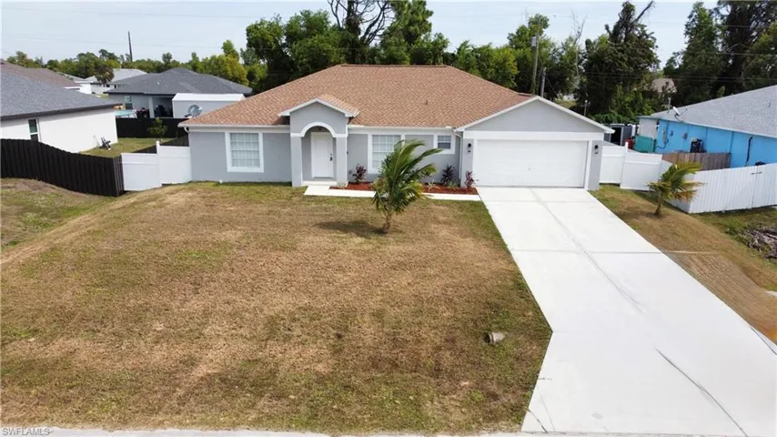 Ranch-style house featuring driveway, stucco siding, a garage, and a shingled roof