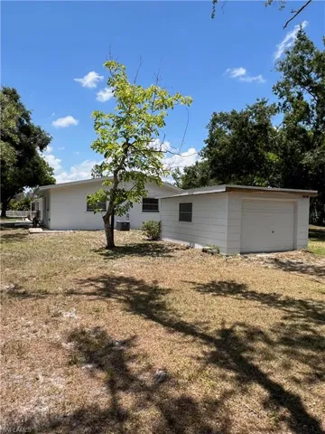 View of front facade with a front yard and central air condition unit