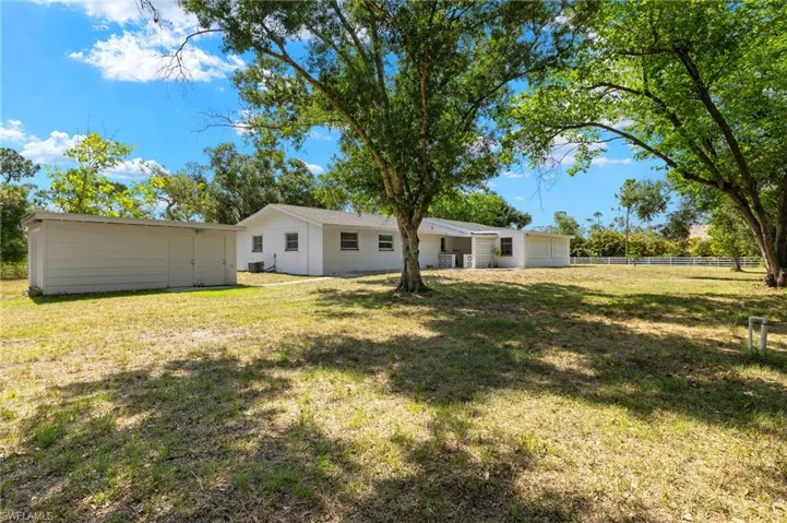 Back of house with a lawn