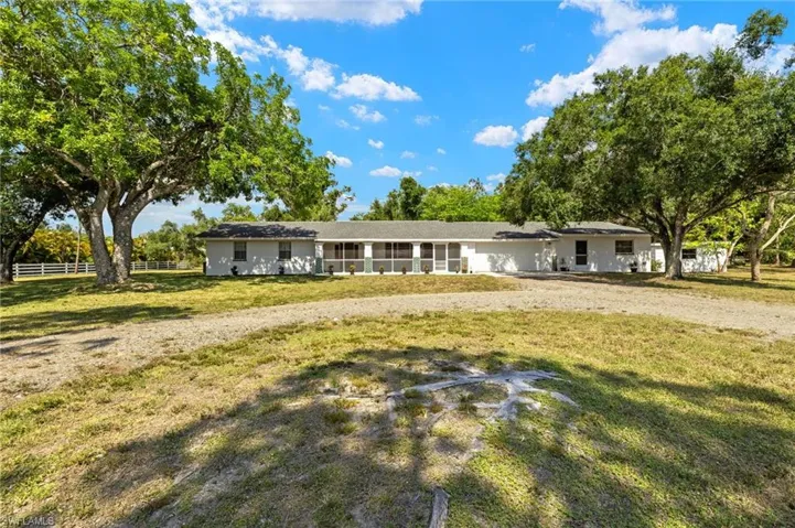 Ranch-style home featuring a front lawn
