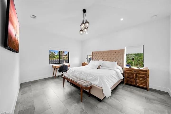 Bedroom with tile flooring and a chandelier