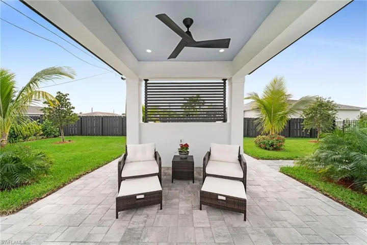 View of terrace with outdoor lounge area and ceiling fan