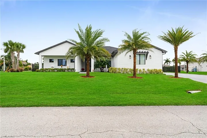 Single story home featuring a front lawn