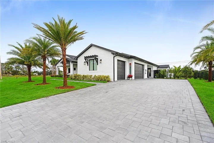Single story home featuring a garage and a front yard