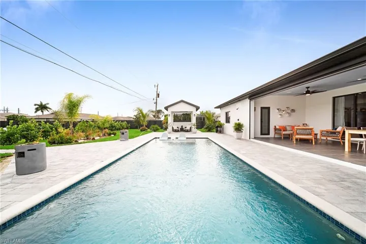 View of swimming pool featuring a patio, an outdoor hangout area, and ceiling fan