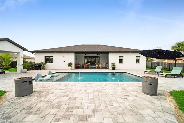 View of swimming pool with a patio area and pool water feature