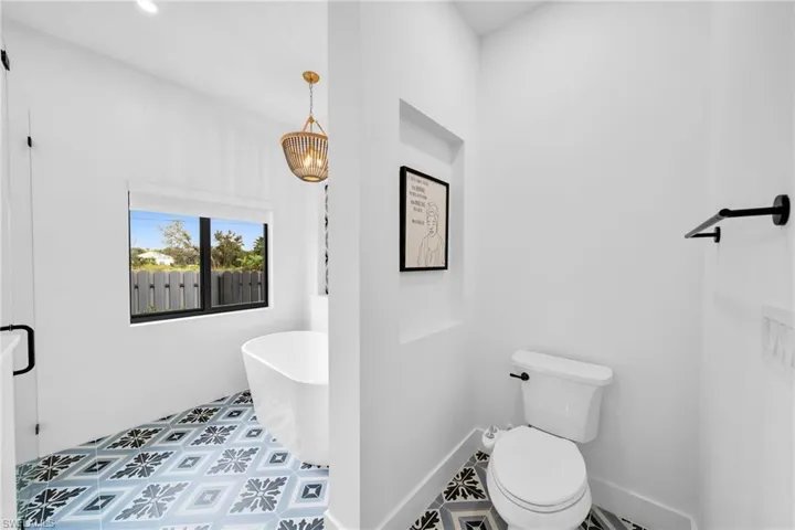Bathroom featuring tile floors and toilet