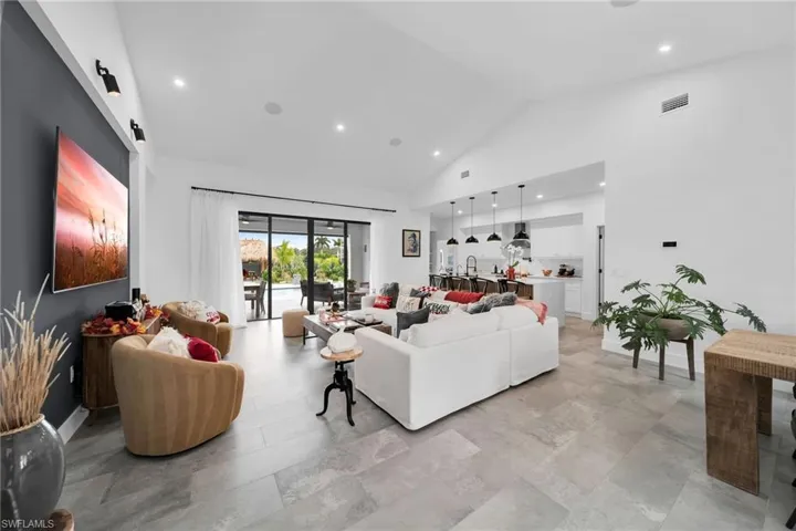 Tiled living room with high vaulted ceiling