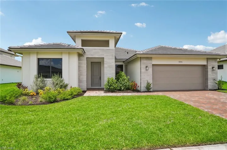 View of front facade with a front yard and a garage