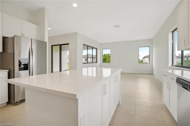 Kitchen featuring white cabinetry, plenty of natural light, appliances with stainless steel finishes, and a kitchen island