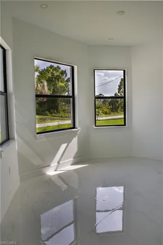 Unfurnished room featuring marble finish floors and recessed lighting