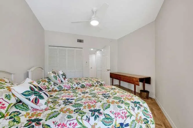 Bedroom with ceiling fan and a closet
