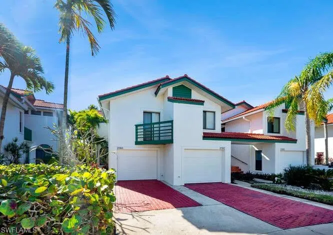 Mediterranean / spanish home with a balcony and a garage