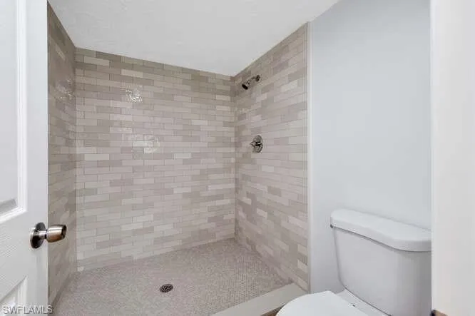 Bathroom with a tile shower and toilet