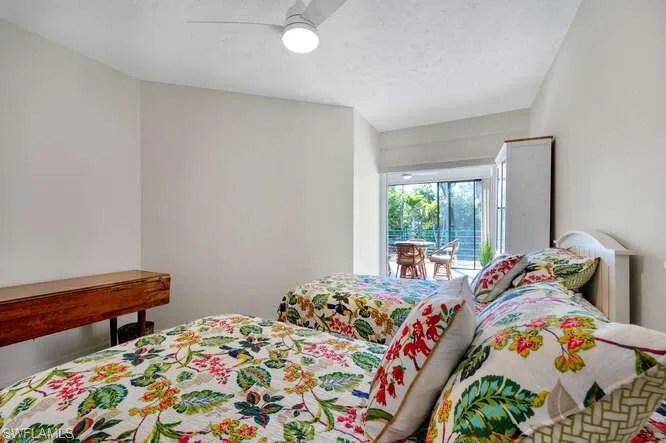 Bedroom with ceiling fan and access to outside